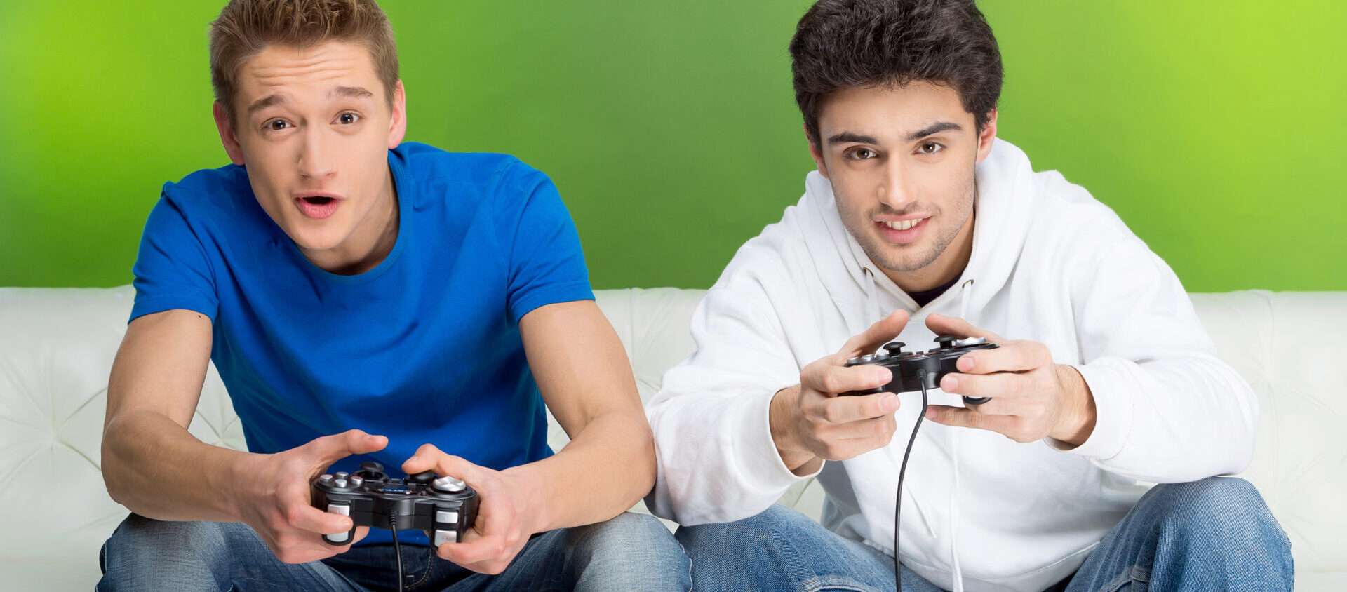 ソファでビデオゲームをしている 2 人の日本人男性。