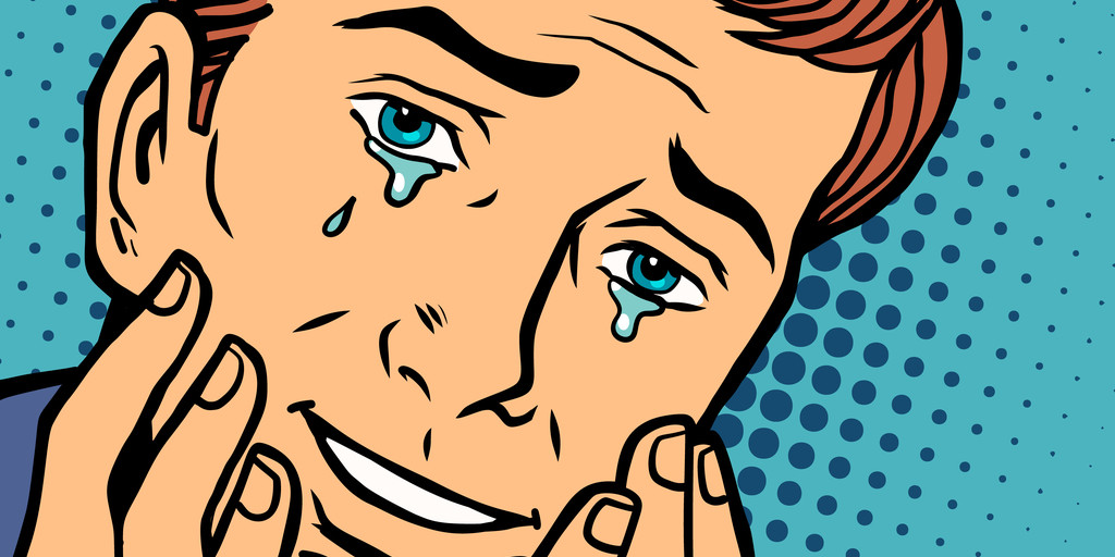 英会話中に顔に手を当てて泣いている男性。